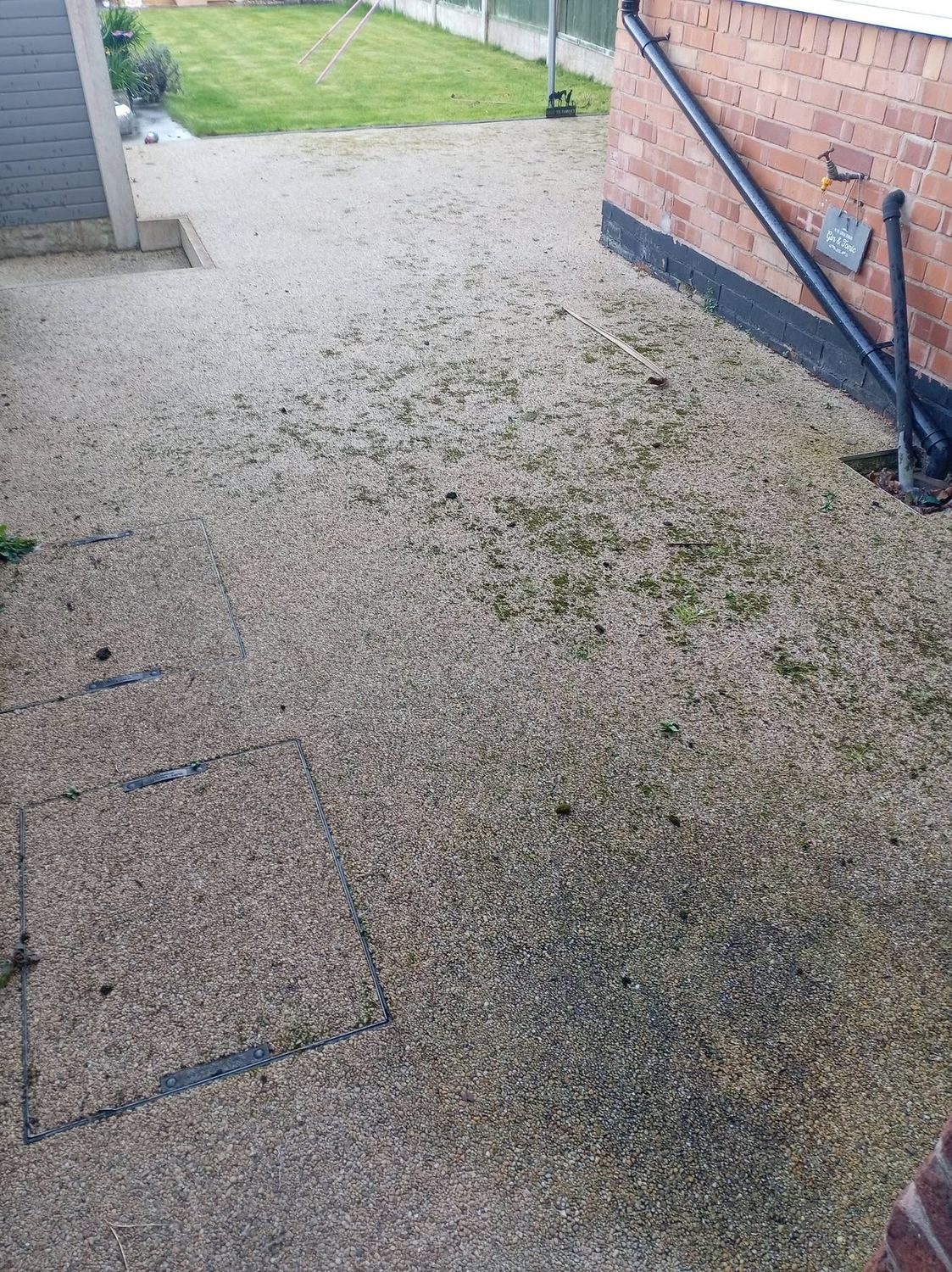 Mossy, algae-covered resin driveway before jet washing in Chesterfield